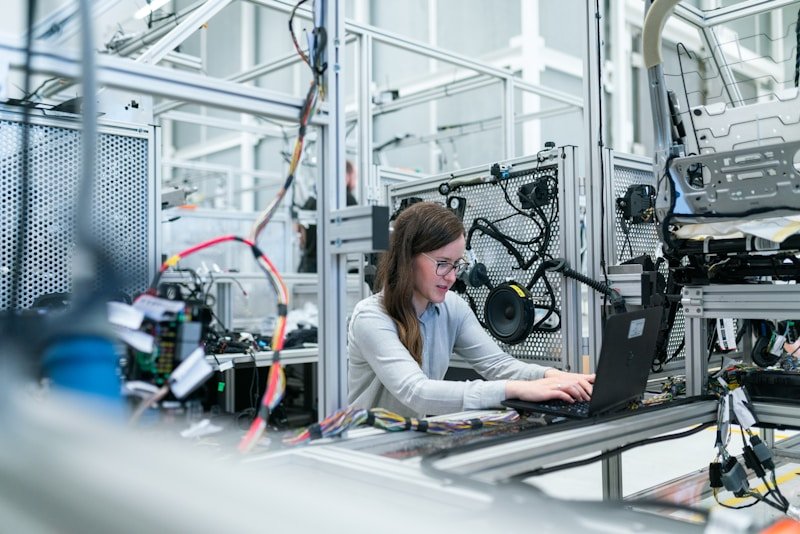 Engineer working with industrial manufacturing equipment and digital controls